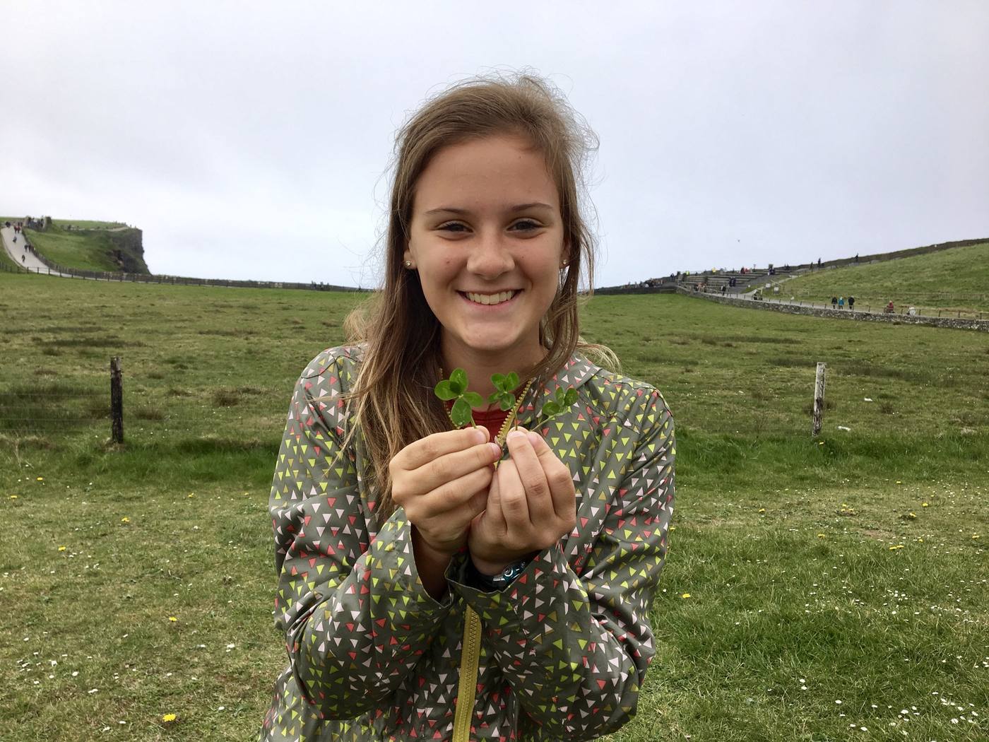 Addie holding a clover at the Cliffs of Moher in Ireland