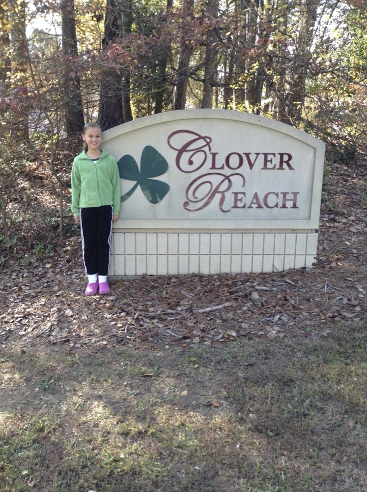 Addie by the Clover Reach sign