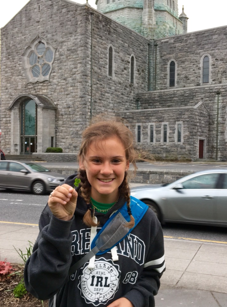 Addie holding a clover in Ireland