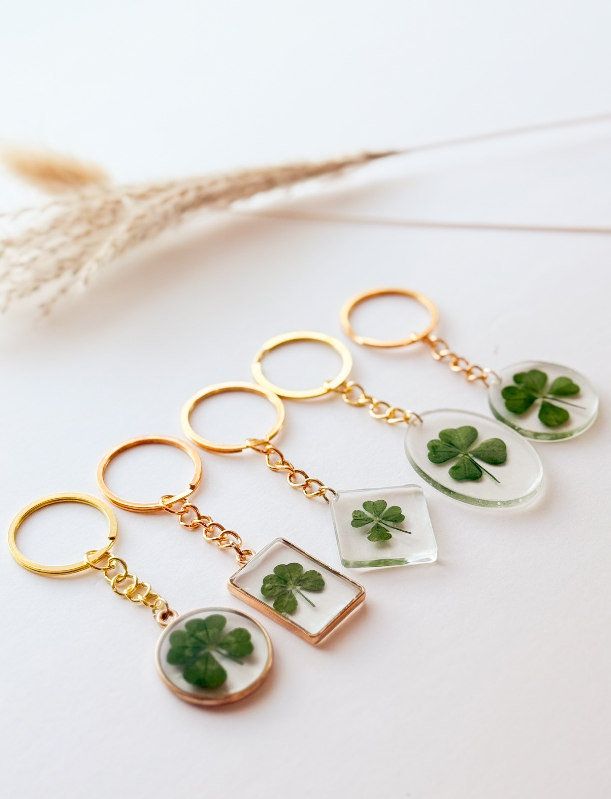 Real four-leaf clover keychains in gold settings