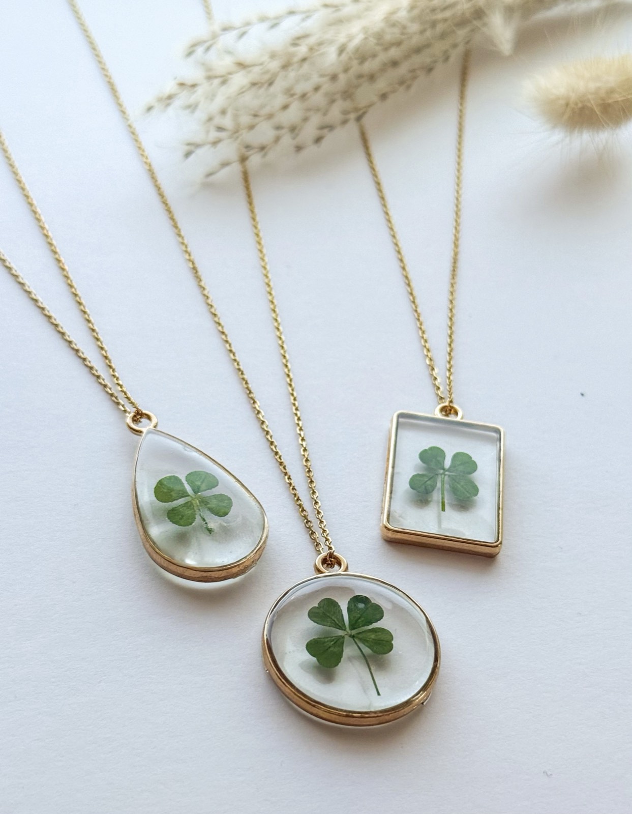 Three real four-leaf clover necklaces with pampas grass