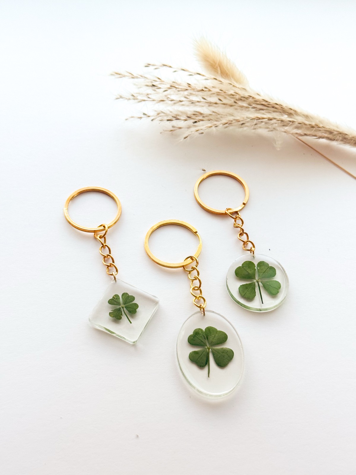 Clear resin four-leaf clover keychains — square, oval and round