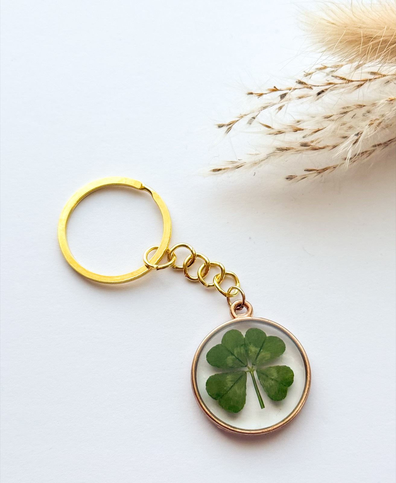 Gold-framed four-leaf clover keychain