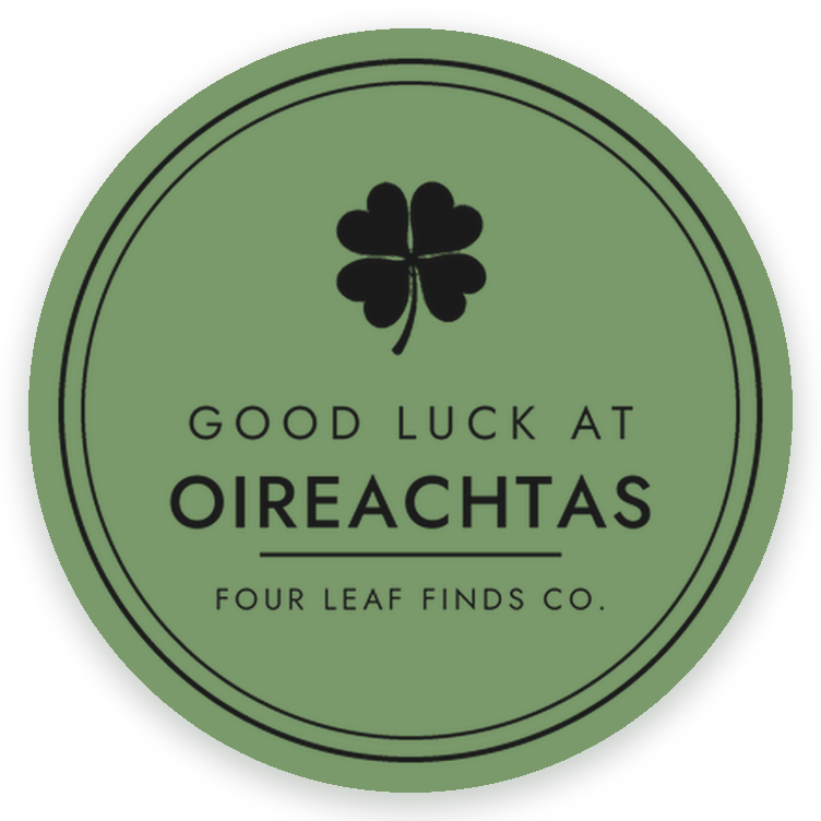 A round green Good luck at Oireachtas sticker with a clover